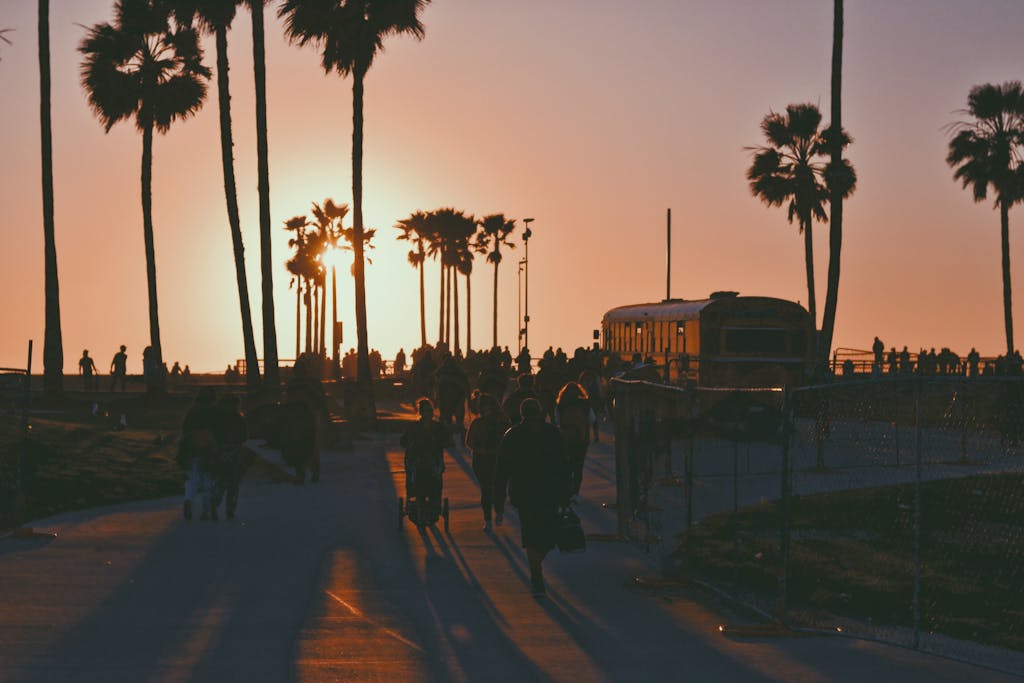 A Crowd Of Walking On The Walkway Of A Park